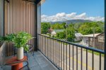 Private covered deck with views of the surrounding mountains. 